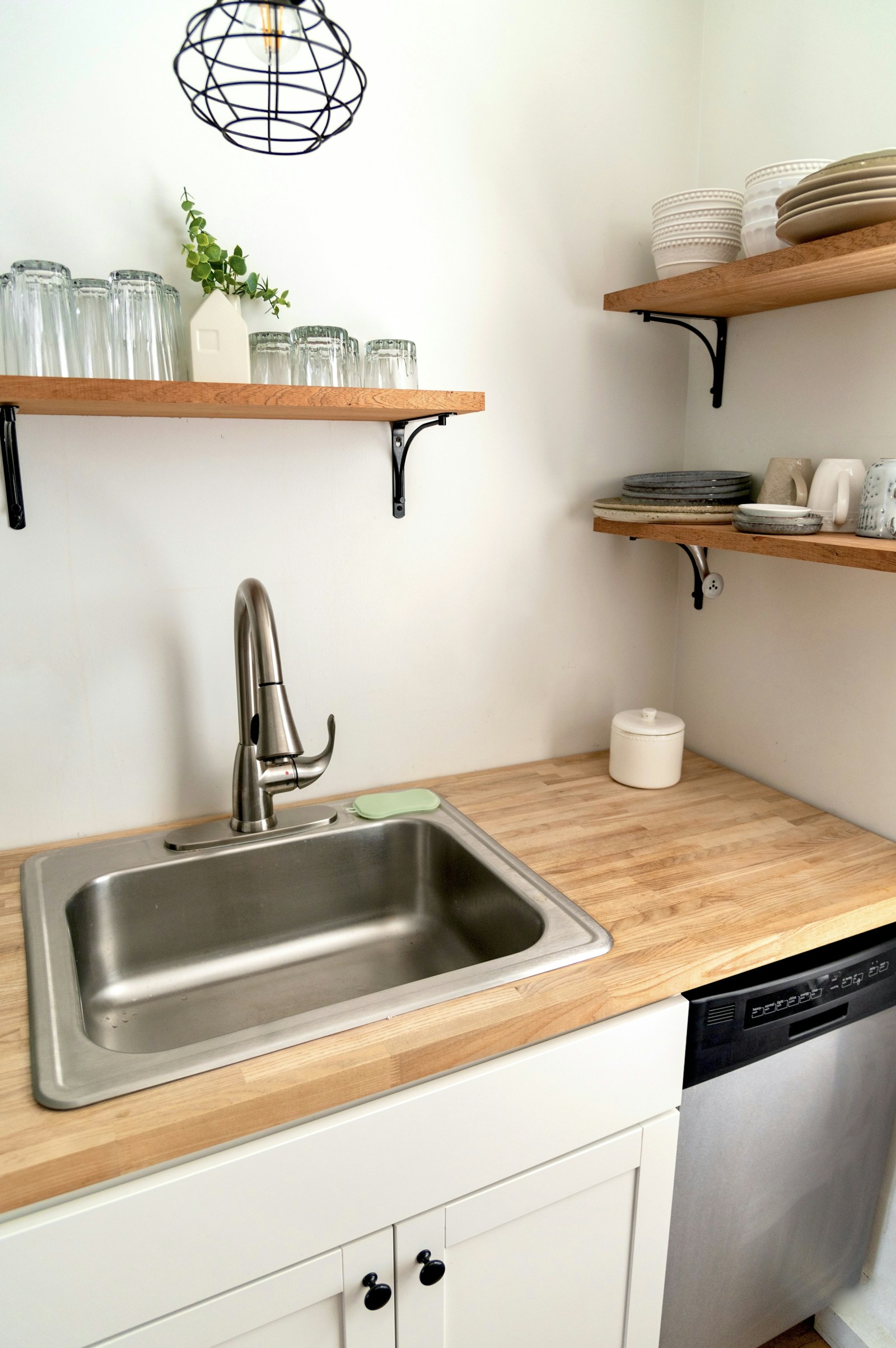 A stainless steel faucet positioned over a kitchen sink