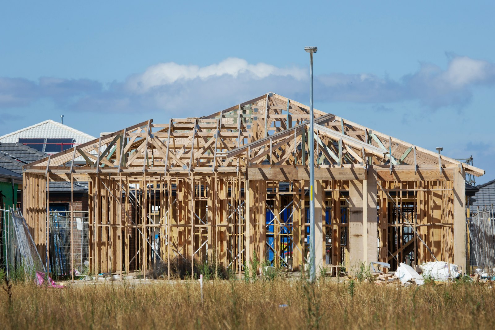 Timber roof trusses and framing on a new residential build; complete roof replacement or new roof installation.